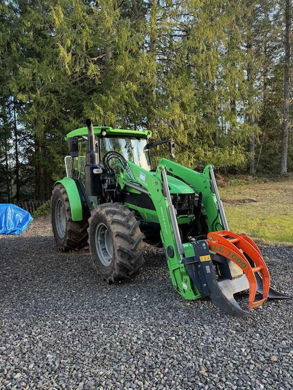 Deutz-Fahr tractor with log grapple — the low-impact equipment behind BOTG forestry consulting